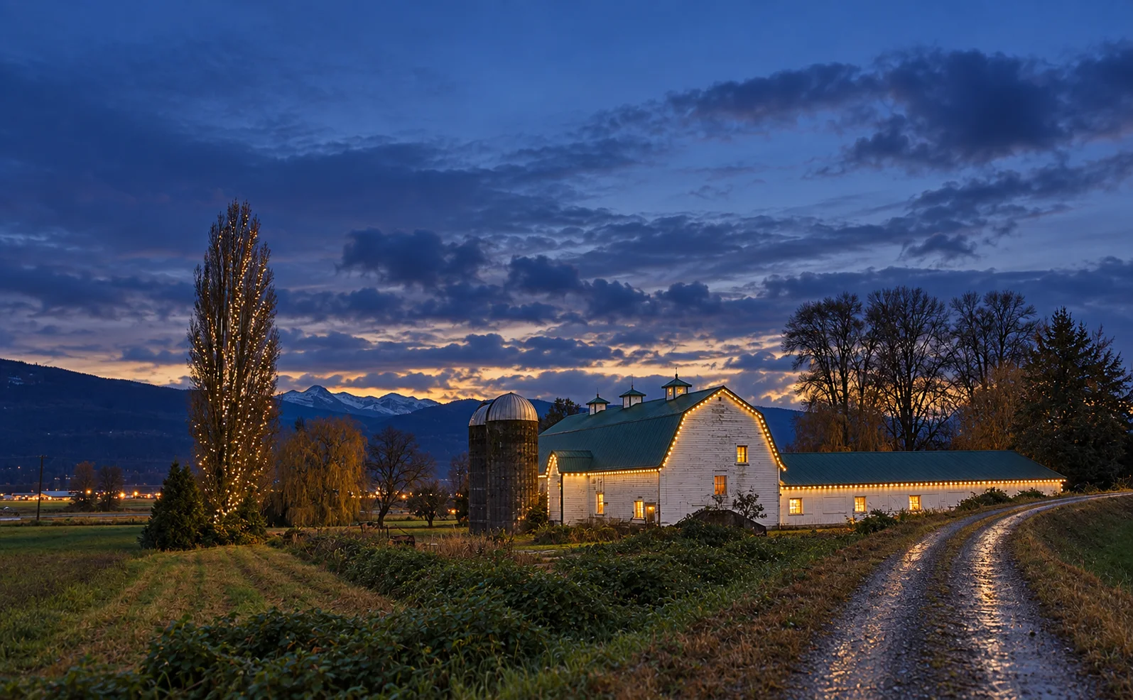 Farmhouse and barn on a rural Abbotsford property with mountains behind